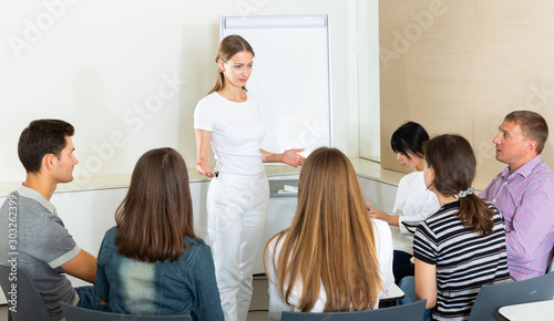 Woman sharing business ideas with colleagues