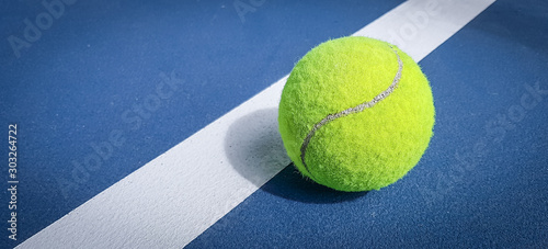 Close-up shots of tennis balls on a blue background field © Ping198