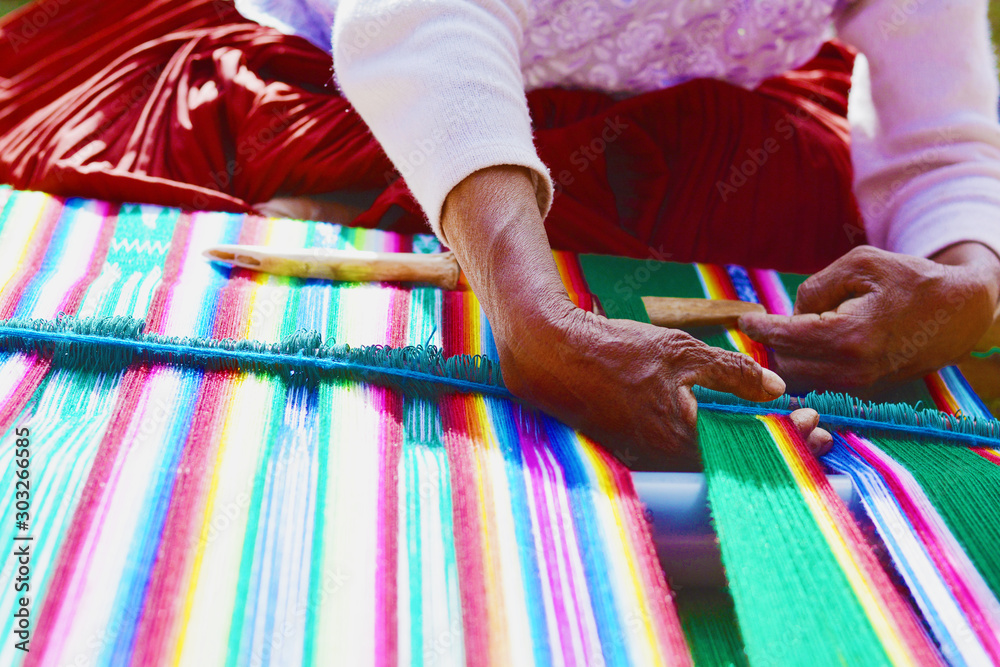 Native american woman sewing colorful clothing. - obrazy, fototapety, plakaty 