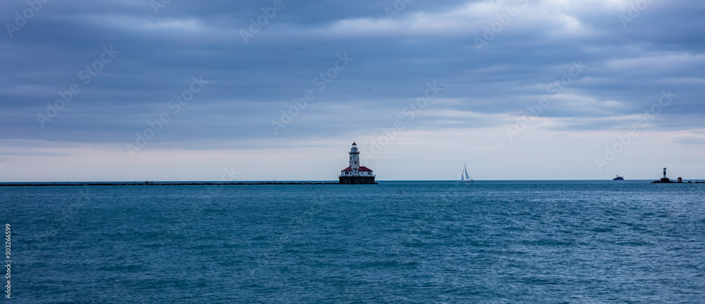 Chicago harbor light in the afternoon, blue lake water and sky background, banner