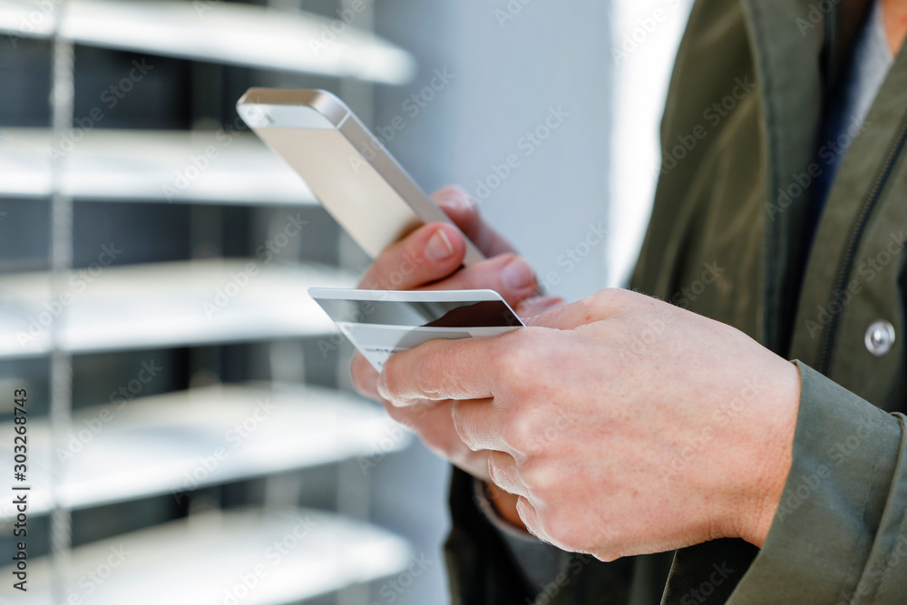 Business person using mobile phone for online banking, online shopping, cashless shopping