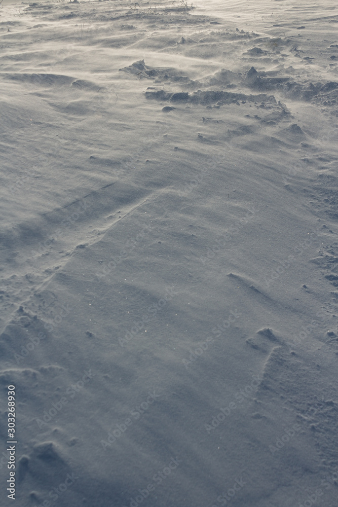 Cold, natural texture. Snow, crust, crust, windy weather. Grey, white colour, background. Winter, loneliness. Slanting Lines, geometry.