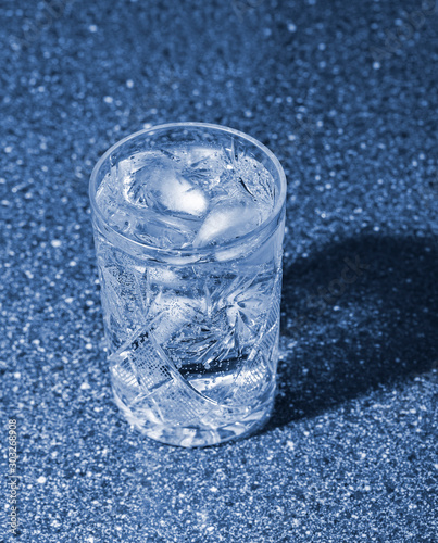 Glass of sparkling water with ice