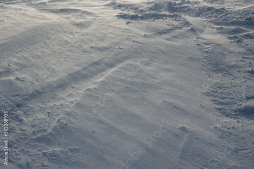 Cold, natural texture. Snow, crust, crust, windy weather. Grey, white colour, background. Winter, loneliness. Slanting Lines, geometry.