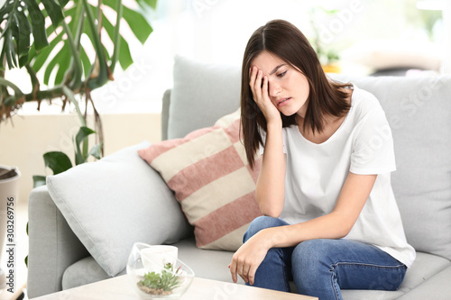 Stressed young woman at home