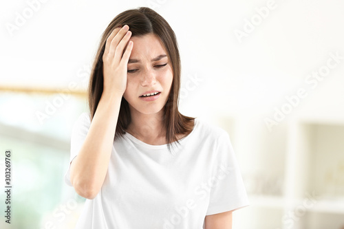 Stressed young woman at home