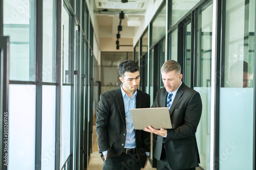 Multiethnic businessmen using a laptop together