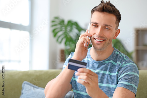 Young man with credit card ...