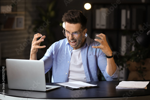 Stressed young man trying t...