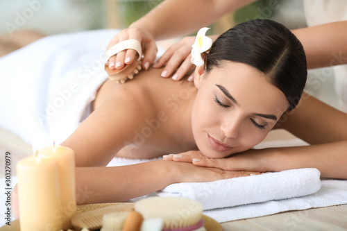 Beautiful young woman relaxing in spa salon