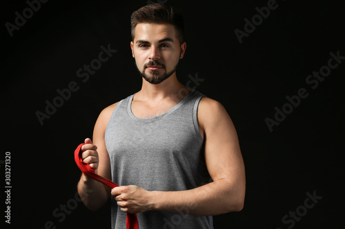 Sporty young man applying w...