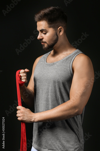 Sporty young man applying w...