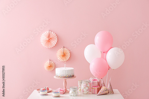 Tasty candy bar for Birthday party on table against color background