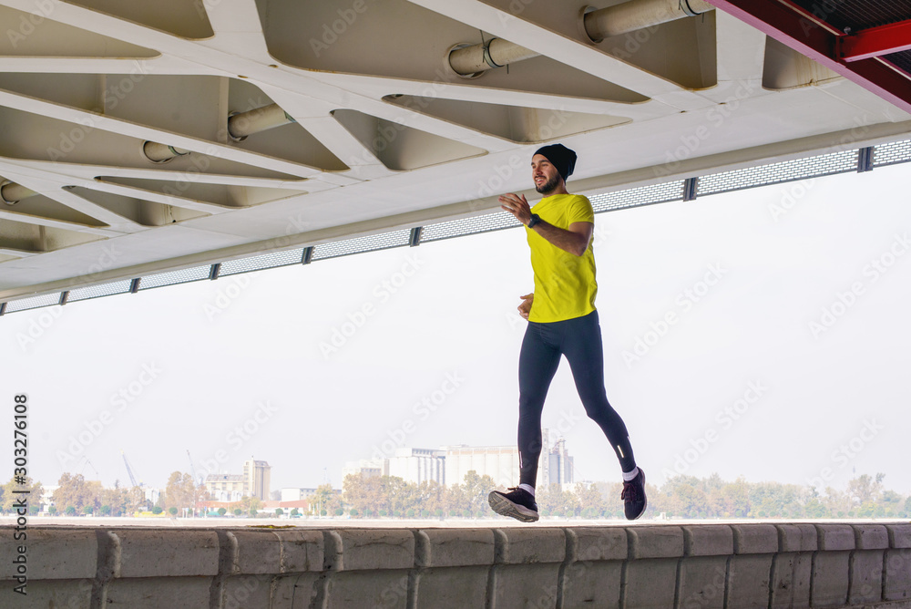 Young man running outdoors in morning Young man running outdoors in morning