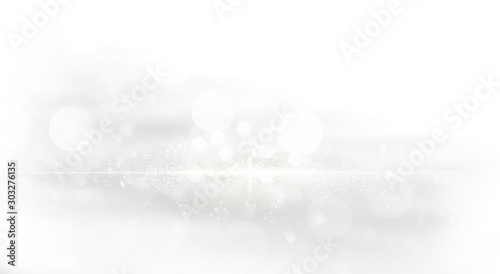 Abstract of glowing bokeh and sparkling shiny glitter with burst effect on silver white background