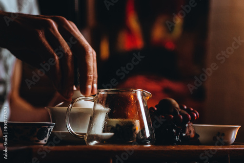 wooden table for tea ceremony background. holding a cup of tea