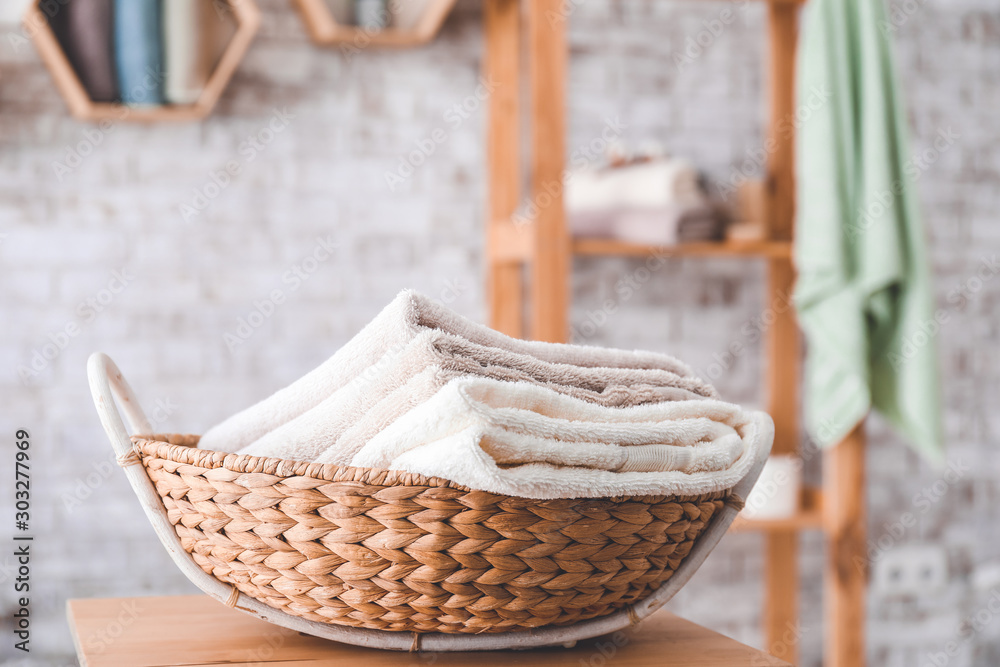 Fototapeta premium Basket with clean towels on table