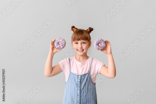 Cute little girl with donut...