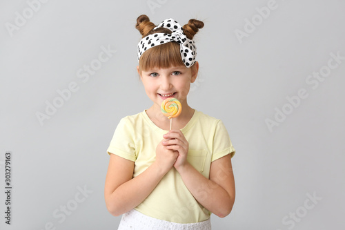 Cute little girl with lolli...