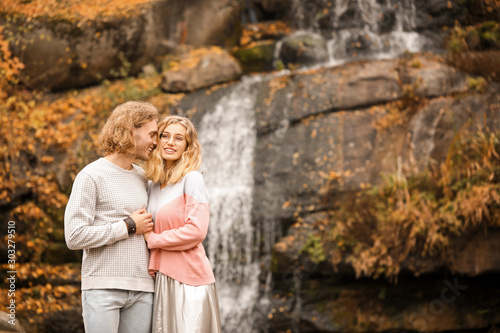 Young couple near waterfall...