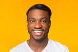 Portrait Of Black Guy Smiling Standing Over Yellow Background