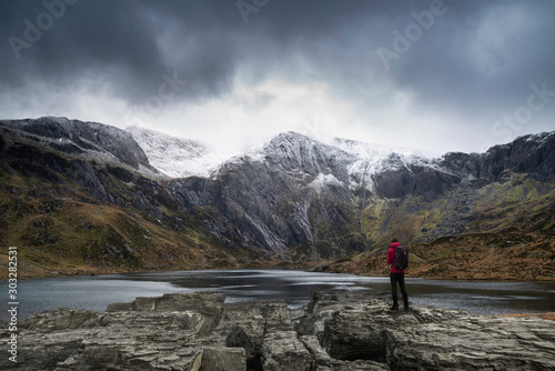 Beautiful moody Winter landscape image of Llyn Idwal and snowcapped Glyders Mountain Range in Snowdonia © veneratio