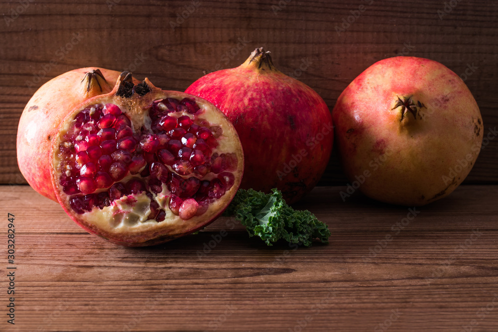 natural pomegranate on rustic wooden background natural pomegranate on rustic wooden background
