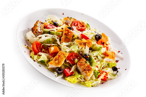 Salad with chicken meat and vegetables on white background