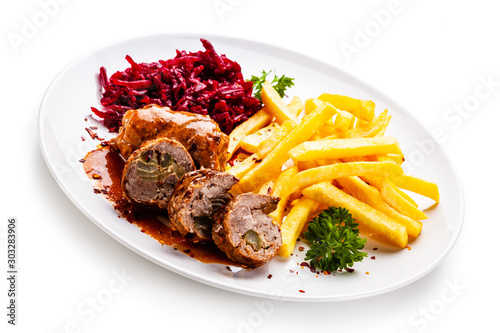 Wrapped pork with french fries and beetroot