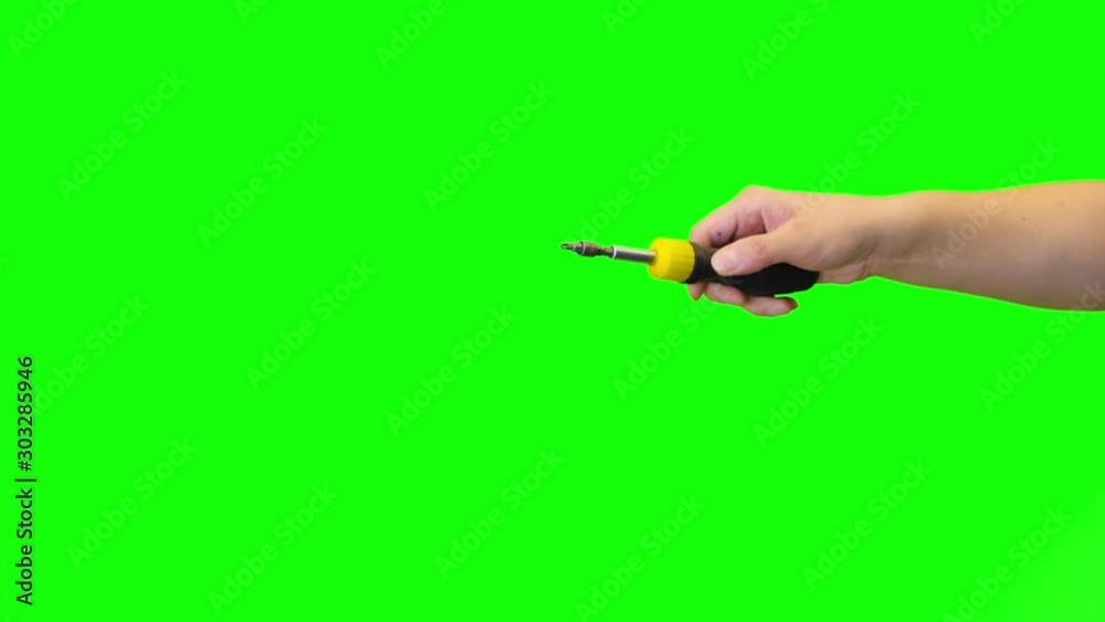 Hand enter and exit Green Screen Chroma key with a Screwdriver screwing a screw Hand enter and exit Green Screen Chroma key with a Screwdriver screwing a screw