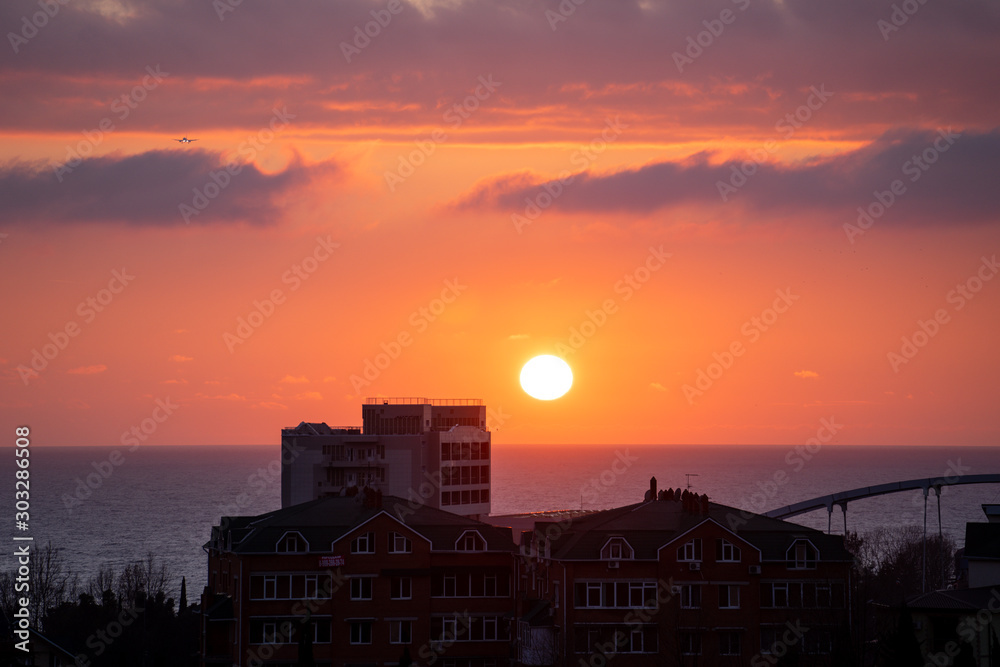 Fototapeta premium Landscape with sunset view over sea and city