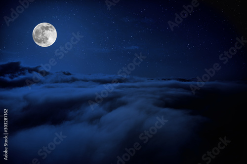 Shone circle of the moon in darkness on a background of the star sky and clouds © zef art