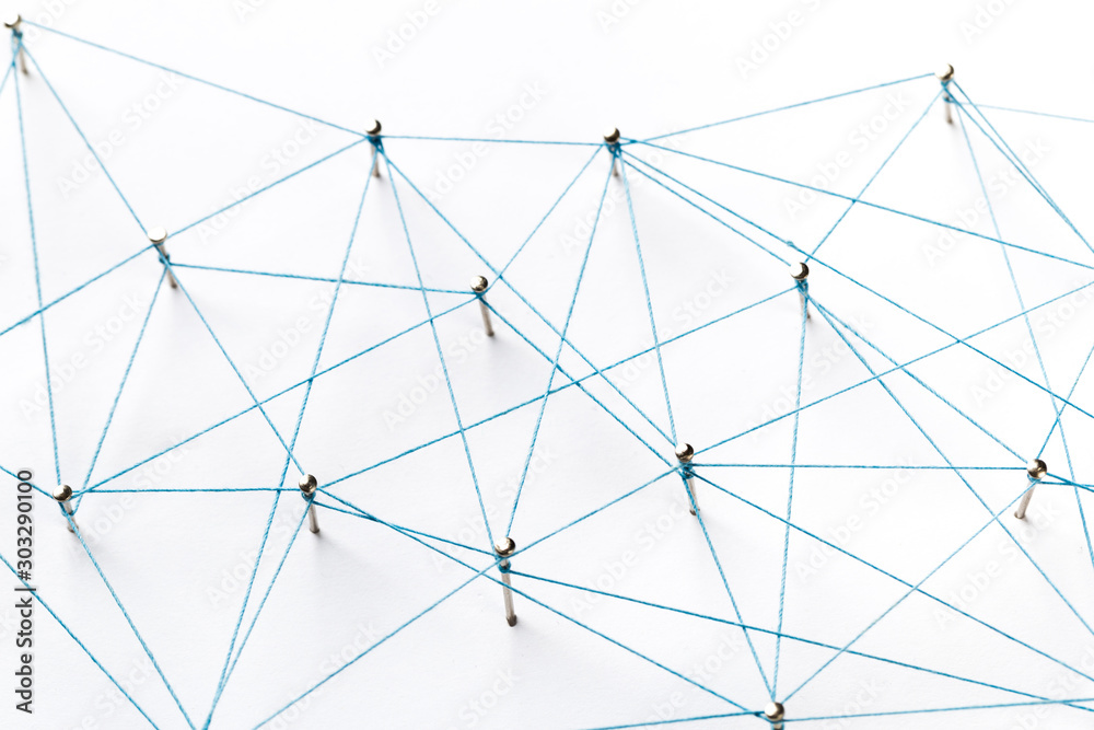 Naklejka premium Communication, technology, network concept. Network with pinsA large grid of pins connected with string. Communication, technology, network concept. Network with pins