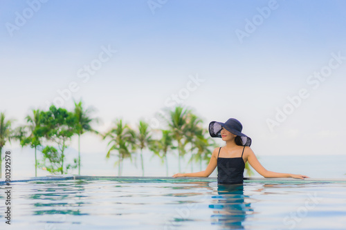 Portrait beautiful young asian women happy smile relax outdoor swimming pool in hotel