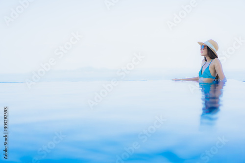 Portrait beautiful young asian women happy smile relax outdoor swimming pool in resort