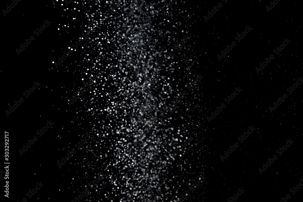Realistic falling snowflakes. Isolated on black background.