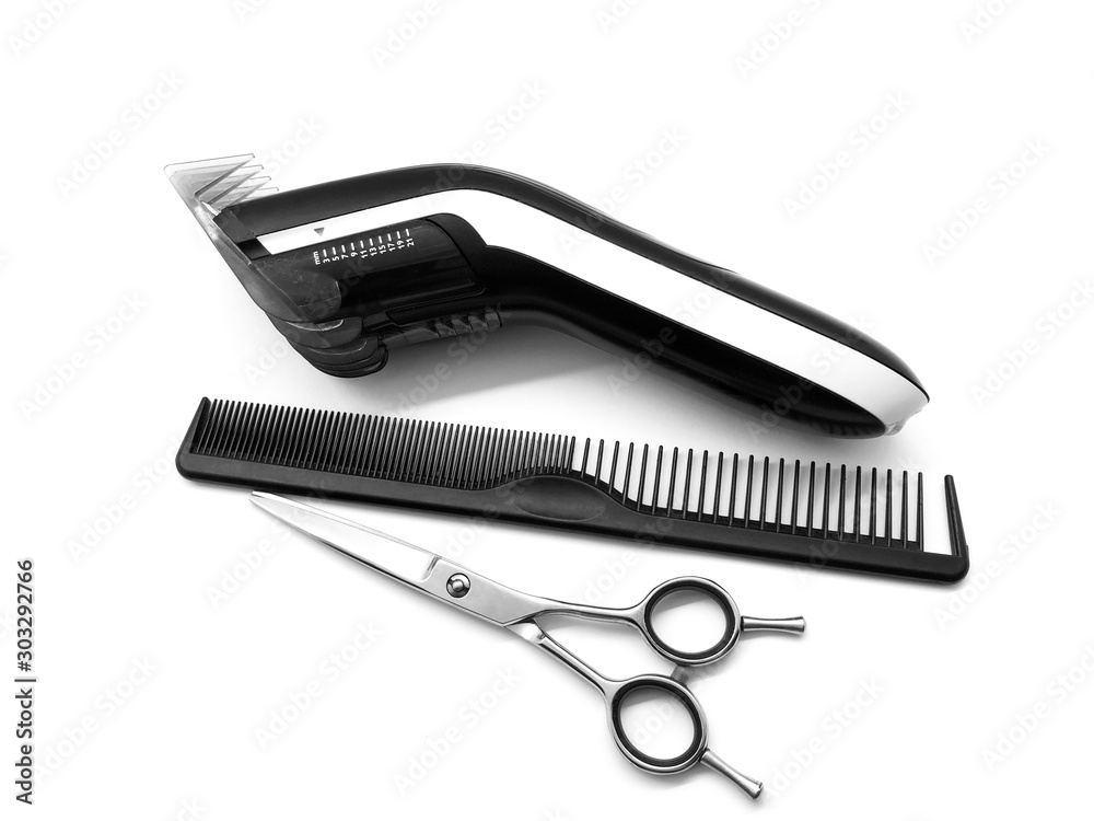 Hair clipper, scissors and comb isolated on white background. Set of hairdressing tools. Set for hair cutting. Composition of professional tools for a beauty salon. Hair clipper, scissors and comb isolated on white background. Set of hairdressing tools. Set for hair cutting. Composition of professional tools for a beauty salon.
