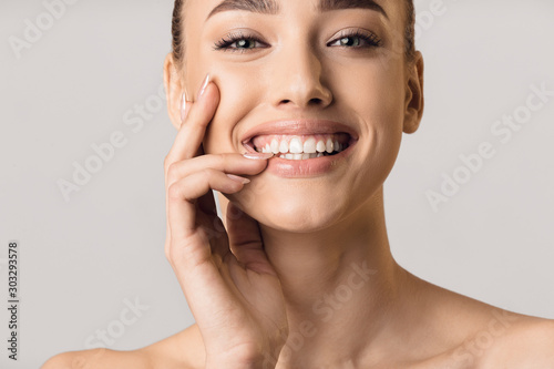 Stomatology concept. Girl with strong white teeth photo