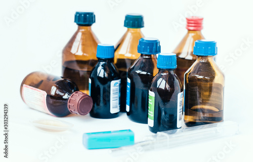 Medicine bottles on white background with copy space for text, retro concept closeup.
