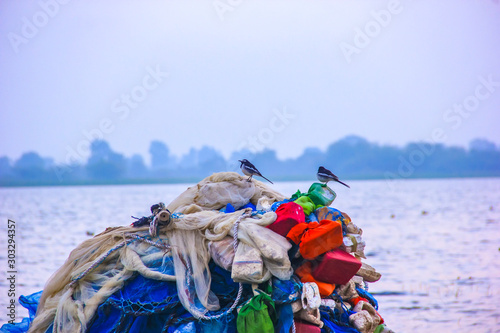 River side view in India, Fisherman fishing on boat in river  