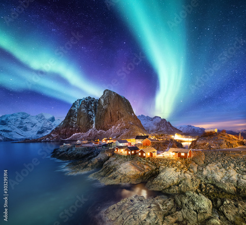 Aurora Borealis above Reine, Lofoten islands, Norway. Nothen light, mountains and houses. Winter landscape at the night time. Norway travel - image
