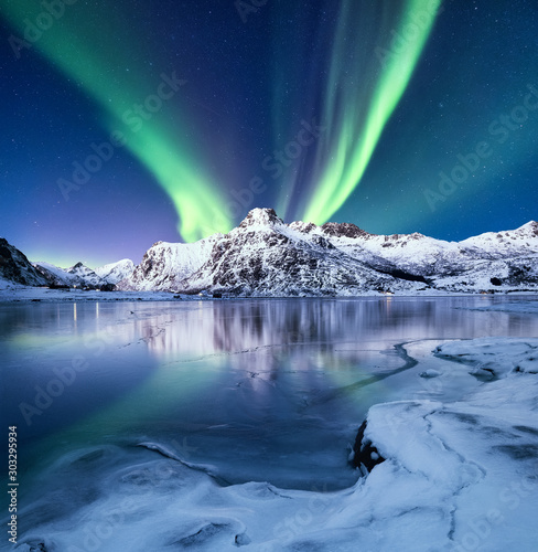 Fototapeta Naklejka Na Ścianę i Meble -  Aurora Borealis, Lofoten islands, Norway. Nothen light, mountains and frozen ocean. Winter landscape at the night time. Norway travel - image