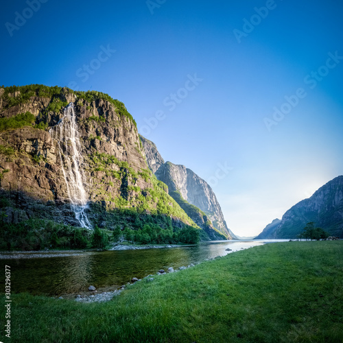Panorama of high cliffs at lysebotn river estuary with waterfall and view into Lysefjord Norway