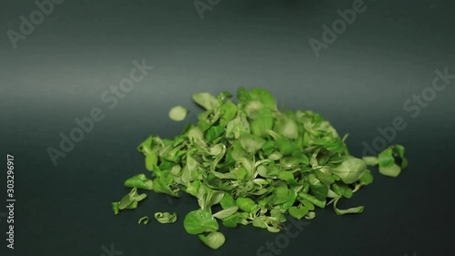 lettuce leaves fall against a dark green background fall from above. spinach. healthy eating
