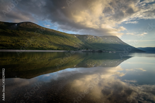 Beautiful shaped mountain ridge reflection in lake Norway Trollheimen