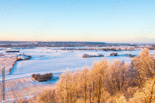 Beautiful landscape view with frosty trees and snow in the countryside in the winter