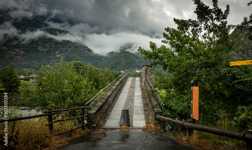 Fototapeta Naklejka Na Ścianę i Meble -  medieval bridge of Echallod over Dora Baltea river, municipality of Arnad, Aosta Valley, Italy	