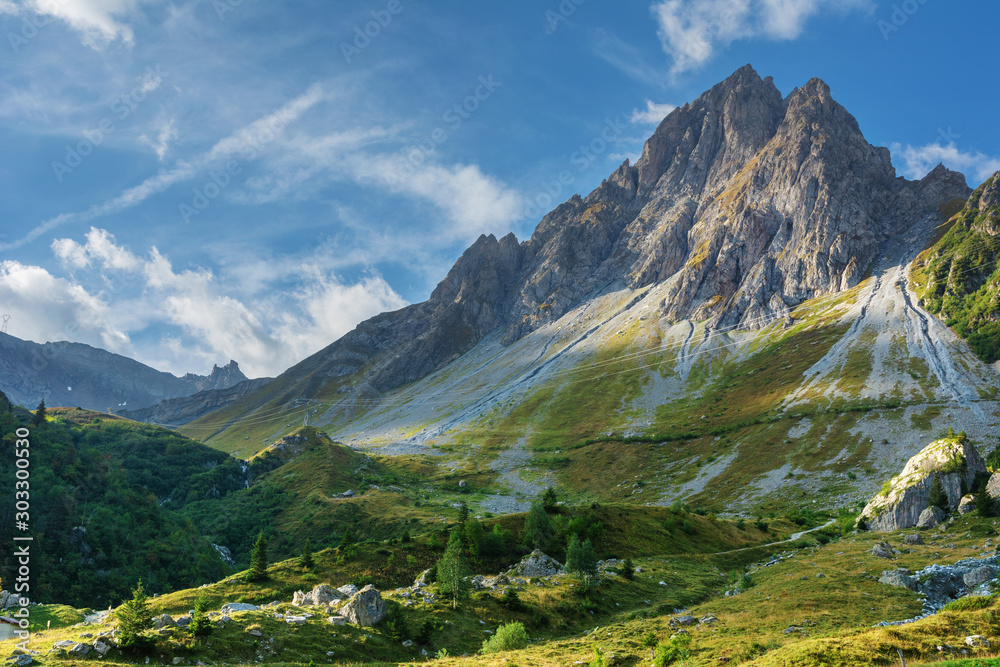 Hiking trails in the French Alps with stunning views of rocky mountains and alpine meadows.