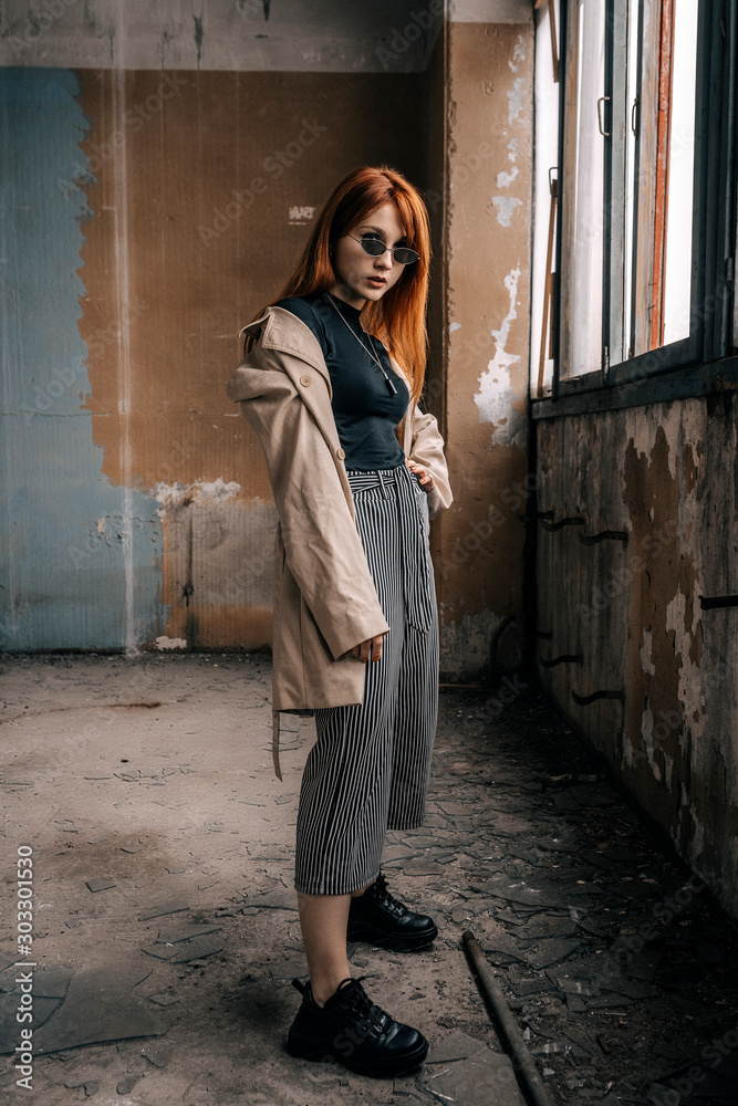 Beautiful girl in a ruined house