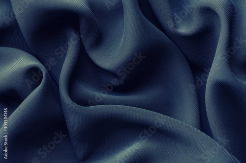 dark blue fabric with large folds, abstract background
